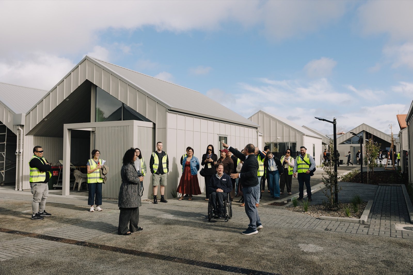 Visitors gathering among the completed homes