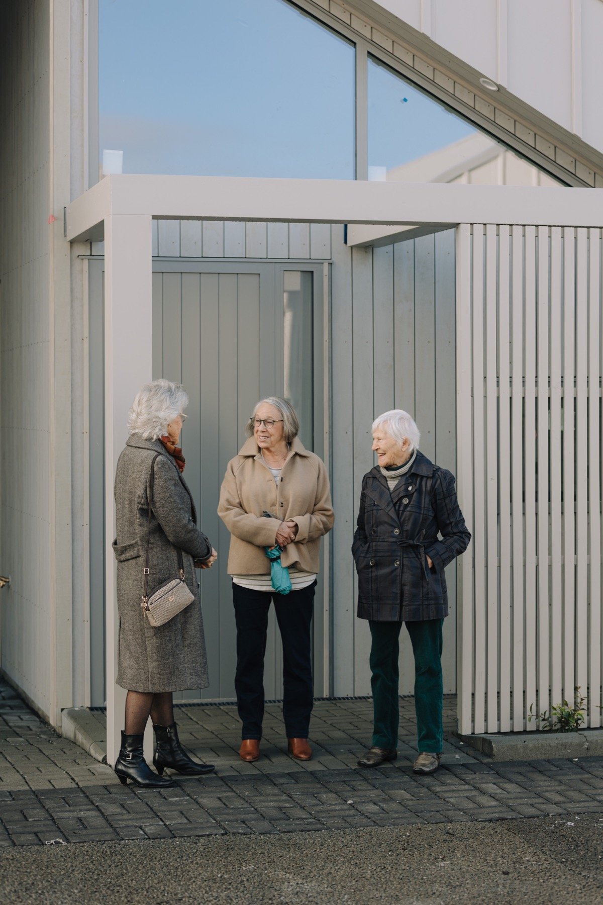 Residents sharing a conversation outside a Notre Dame Living home